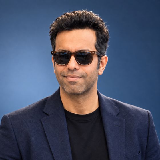 Sanil Nadkarni in a navy blazer against a blue backdrop